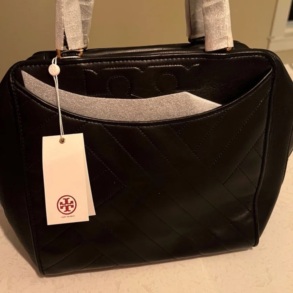 Beautiful satchel! Brand new! Leather is super soft.